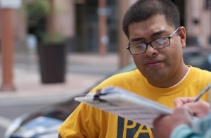 Jose Barboza, a volunteer for Promise Arizona, works to get people registered to vote. (Photo by Courtney Columbus/News21)