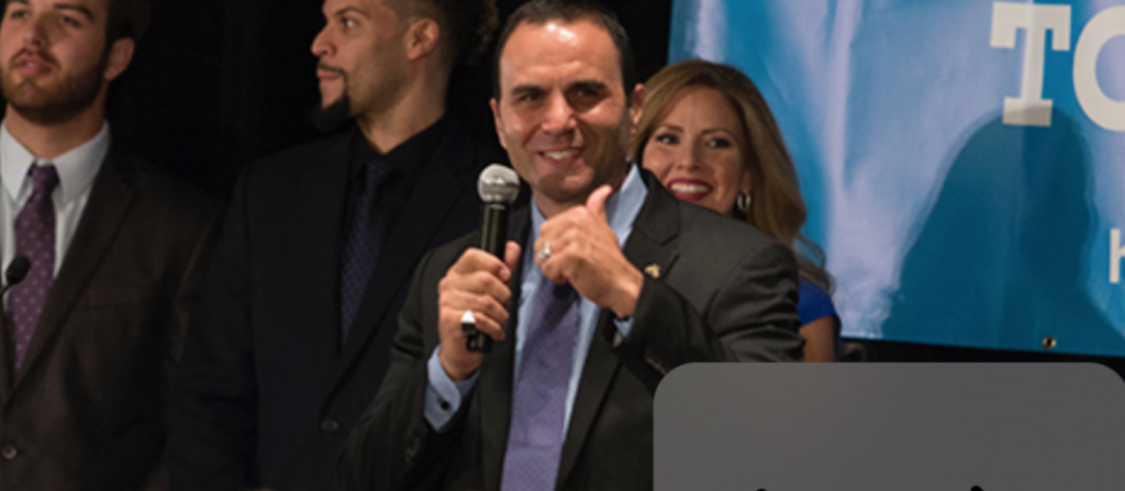 “There’s a new Sheriff in town,” someone yells from the crowd gathered at the Democratic watch party. Paul Penzone will replace Joe Arpaio as Sheriff of Maricopa County. (Photo by: Ally Carr/Cronkite News)